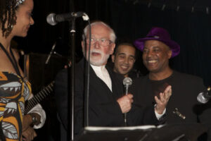 a Papuan bewildered (before he is thrilled)in the midst of the laughing musicians.